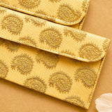 Golden paisley patterned brocade fabric money envelope with textured fabric and stitched edges for indian weddings and gifts