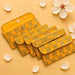 Vibrant yellow brocade fabric money envelopes with paisley pattern and metallic button closures for indian weddings and gifts