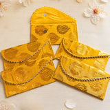 Brocade fabric money envelopes in bright yellow with gold floral embroidery and silver beaded edges for Indian weddings