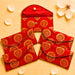 Red satin brocade fabric money envelope with gold paisley embroidery and metallic button closures for cash gifting