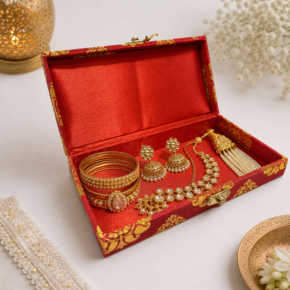 Red and gold brocade gift box with satin lining holding traditional indian bridal jewelry for wedding favors