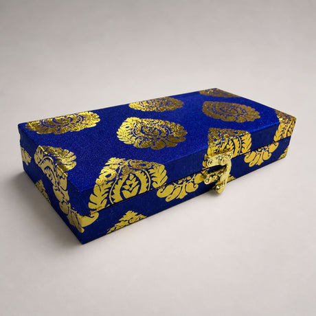 A rectangular blue brocade fabric gift box with gold floral patterns and clasp for indian muslim wedding favors