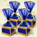 Blue and gold brocade potli gift boxes with sheer organza tops and tassels for traditional indian wedding favors
