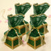 Emerald green velvet brocade potli gift boxes with gold trim and organza lids tied with pearl tassels for wedding favors