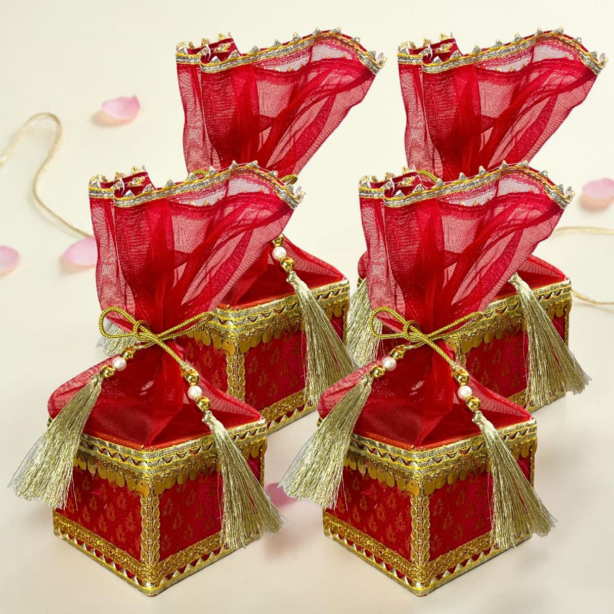 Brocade potli gift boxes in red and gold with sheer red organza tops tassels and embroidered borders for wedding favors