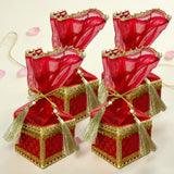 Brocade potli gift boxes in red and gold with sheer red organza tops tassels and embroidered borders for wedding favors