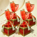 Red and gold brocade potli gift boxes with sheer red organza bows pearl beads and silver tassels for traditional indian weddings