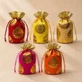 Traditional Indian brocade print silk potli bags in vibrant red yellow gold pink and orange with golden paisley patterns