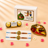 Golden ornate designer rakhi with brown beads and blue thread in a handmade Raksha Bandhan gift hamper for brother and bhabhi