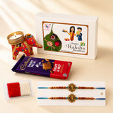 Red and gold embroidered elephant-shaped candle holder in a designer rakhi gift hamper for brother and bhabhi