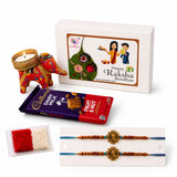 Red and gold embroidered elephant-shaped candle holder in a designer rakhi gift hamper for brother and bhabhi