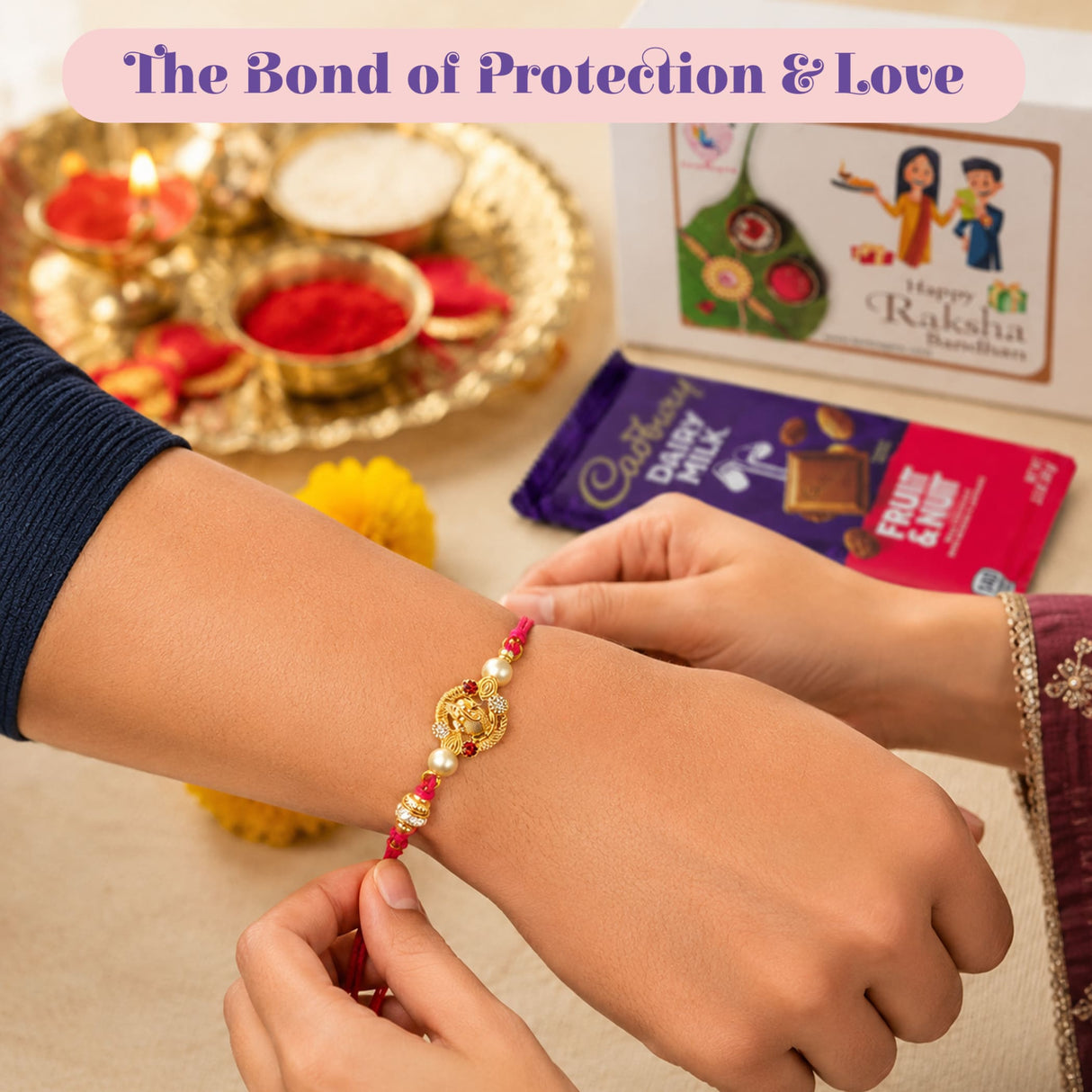 A golden raksha bandhan bracelet with red beads and white pearls in a ganesha rakhi gift hamper set for brother and bhabhi