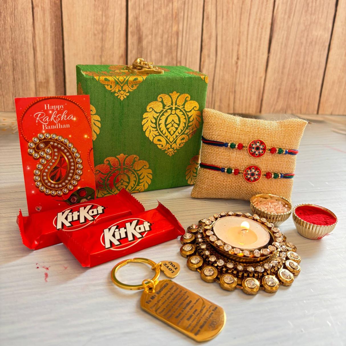 Designer rakhi gift hamper gold ornate candle holder with lit tealight and decorative crystals for brother and bhabhi