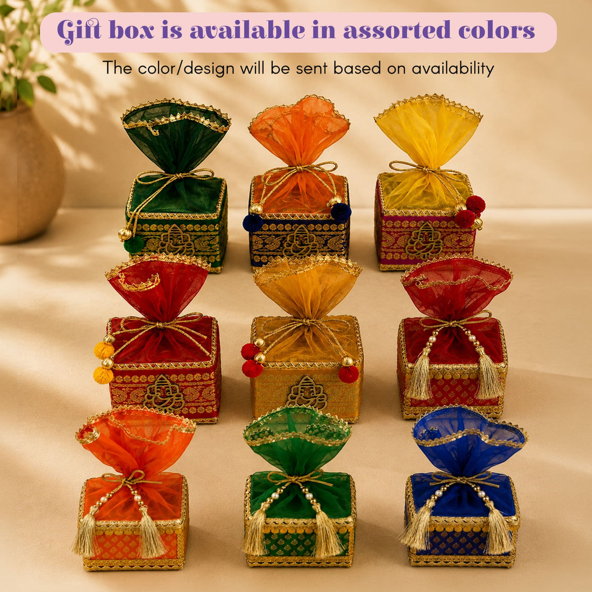 Assorted colorful gift boxes with gold-trimmed fabric lids and decorative tassels in designer rakhi gift hamper set for brother and bhabhi