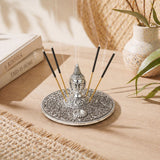 Silver buddha-themed german silver incense holder with intricate filigree and central circular ash tray for temple decor