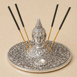 Silver Buddha head incense holder with intricate floral patterns and circular ash tray for temple room decoration