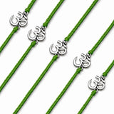 Green cord om bracelets with silver-colored charms for raksha bandhan gift signaling protection and good luck