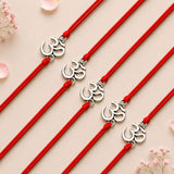 Red cord bracelets with silver colored om symbol charms for traditional raksha bandhan gift protecting brother