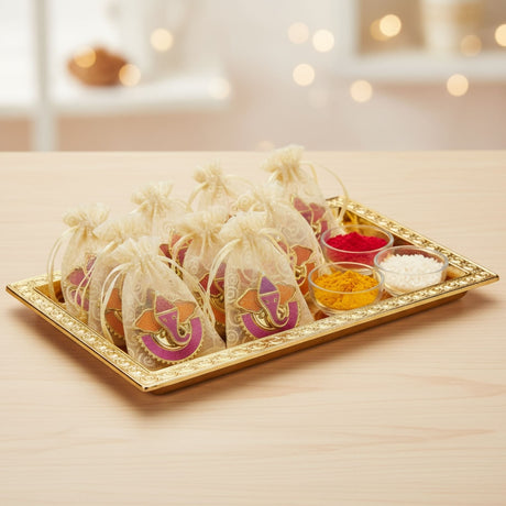 Gold tray with colorful powders and decorative bags for Diwali Ganesha festival celebration