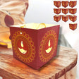 Red paper lantern with cutout Diya designs and gold accents for Diwali decoration