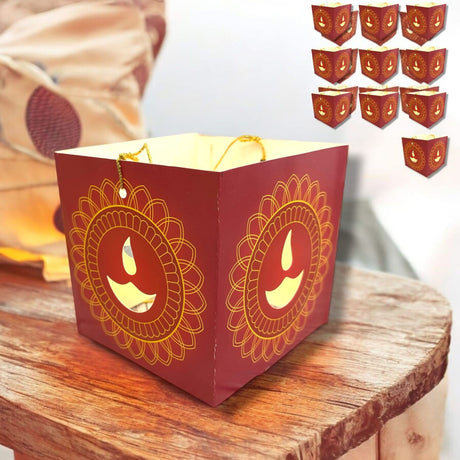 Red paper lantern with cutout Diya designs and gold accents for Diwali decoration