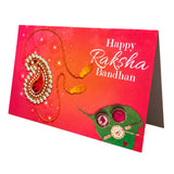 Vibrant red bulk rakhi greeting card set featuring a gold and white jeweled rakhi with orange tassels and green leaf motifs