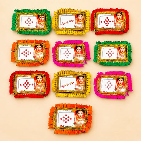 Colorful fringed decorative photo frames with images of women in traditional indian attire for bindi booklet collection