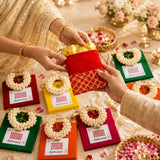 Red and gold quilted drawstring pouch with golden trim in varalakshmi vratham gift hamper for pooja and festivities