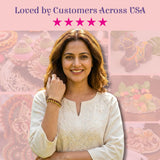 Woman in white embroidered top wearing gold Rudraksha bracelet