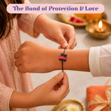 A vibrant red plastic train charm on a black elastic band cartoon rakhi bracelet for brother protection gift