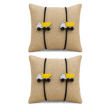 Beige woven fabric square pillow with black elastic bands and yellow dump truck charms for cartoon rakhi gift set
