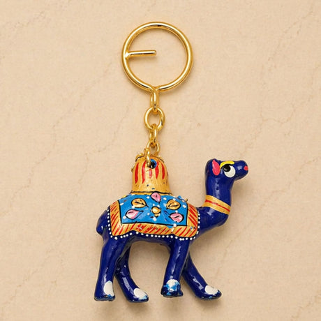 A vibrant blue handmade ceramic camel keychain with gold pink and orange patterns, ideal indian good luck charm