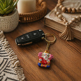 Handmade ceramic ganesha amulet keychain with colorful pink and red details on a gold chain for gifts and backpacks