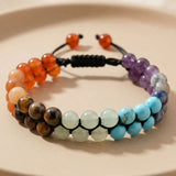 Colorful beaded chakra bracelet for men and women with woven black cord and orange purple blue brown gemstones
