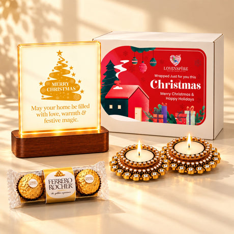 Golden ferrero rocher chocolates in clear and gold foil wrapper in a christmas gift hamper with tealight candle holders