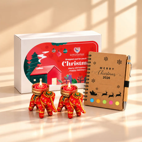 Red intricately embroidered elephant-shaped tealight candle holders with lit candles in festive keepsake box gift hamper