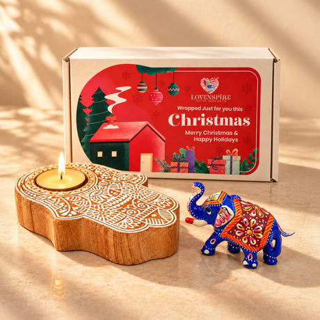 Wooden hand-shaped tealight candle holder with intricate white carvings inside festive christmas gift hamper box