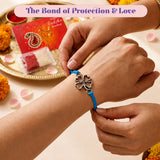 Silver four-leaf clover charm rakhi bracelet with vibrant blue cord for protection and good luck gift