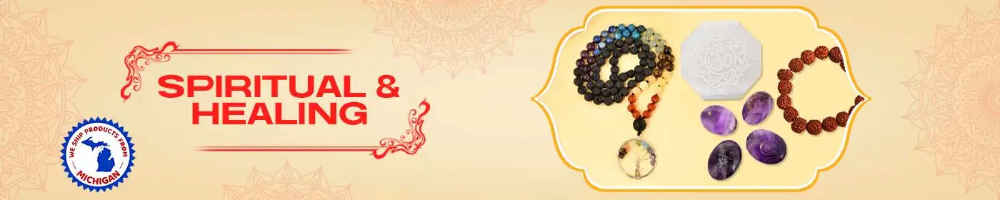 A collection of spiritual and healing items including mala beads, crystals, and a white carved stone.