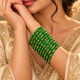 A stack of vibrant green 12ct glass bangles with gold-colored embellishments perfect for bridal and wedding gifting