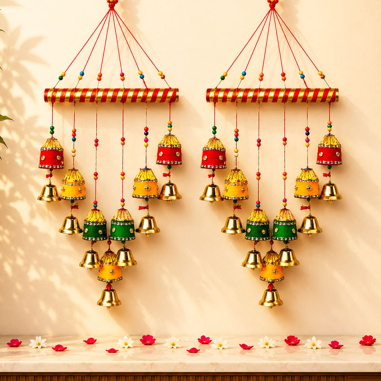 Two Indian wind chimes with red and gold striped tops and colorful bells for home wall and outdoor decor