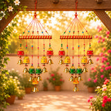 Colorful indian wind chimes with red yellow green and gold metal bells hanging from a striped wooden bar for decor
