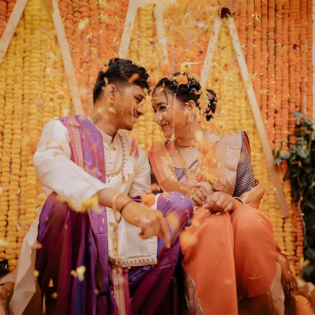 A young couple in traditional Indian wedding attire