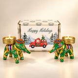 Two green elephant-shaped tealight candle holders with gold accents and floral patterns for festive gifting gift box