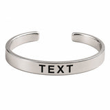 Silver-toned open cuff bracelet with smooth polished finish and engraved black text personalized for birthdays and anniversaries