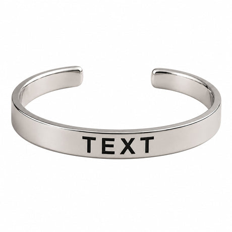 Silver-toned open cuff bracelet with smooth polished finish and engraved black text personalized for birthdays and anniversaries