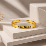 Gold-colored personalized custom name cuff bracelet with smooth metallic finish and engraved text your name