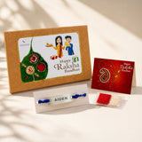 Personalized stainless steel name rakhi with blue thread and silver plate engraved aiden displayed on white stand