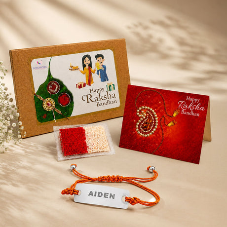 Personalized stainless steel name rakhi with orange braided cord and custom engraved aiden tag for brother gift hamper