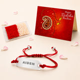 Personalized stainless steel name rakhi bracelet with red braided cord and engraved silver plate for brother gift hamper